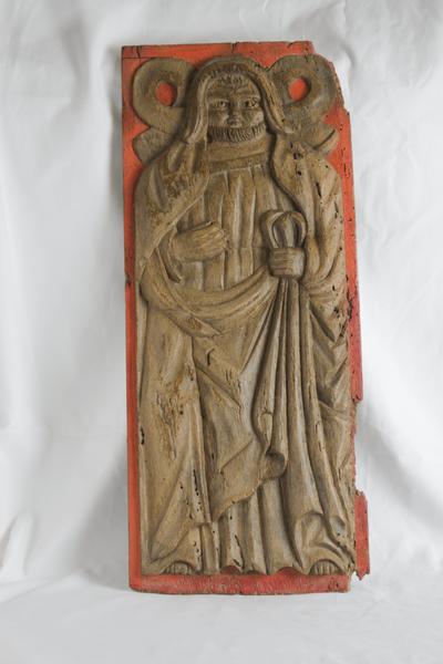 Wooden panel carved with a picture of a monk