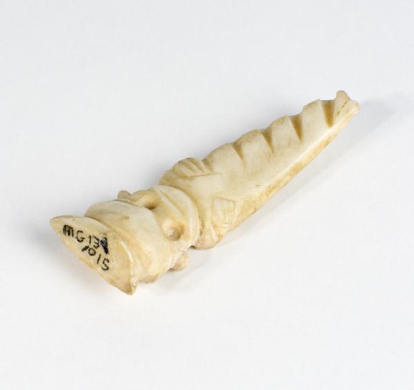 Carving of a child in a carrier